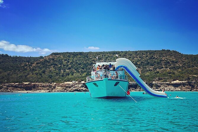 Blue Lagoon trip with slide & music departing from Latchi harbour - Onboard Fun: Inflatable Slide, Changing Room, and the Music Factor