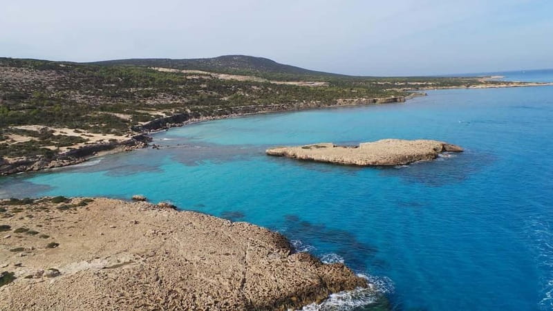 From Latchi: Blue Lagoon Tour via Karnic SL800 Boat - A captain who customizes your route, plus music and stories